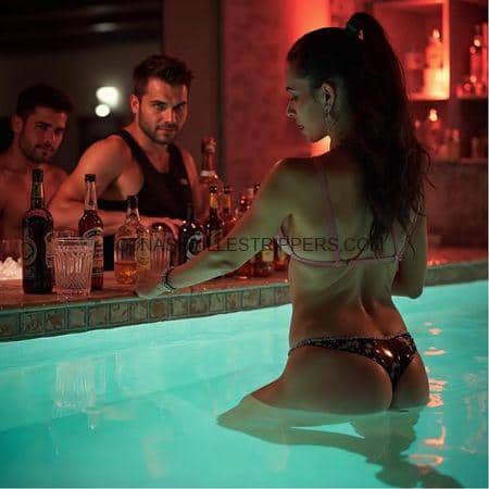 A woman in a bikini sitting in a pool with two men